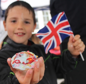 RE-TREAT FROM THE RAIN: Gregor Webster holding a biscuit he decorated under shelter, during rain at the event. 